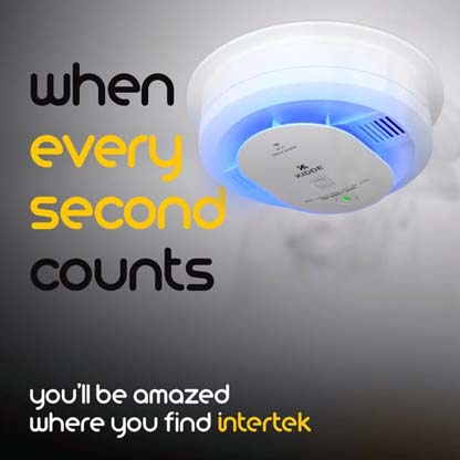 A ceilng-mounted smoke detector/alarm with smoke floating underneath