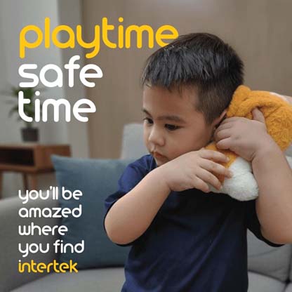 A young buy holding a stuffed animal next to his head